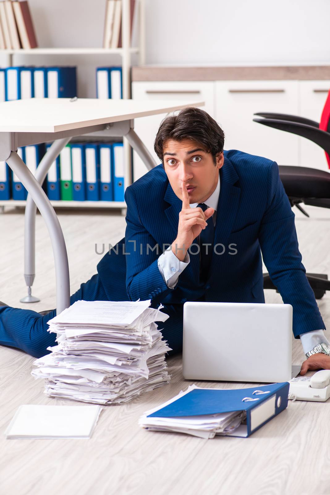 Tired exhausted businessman working overtime in office