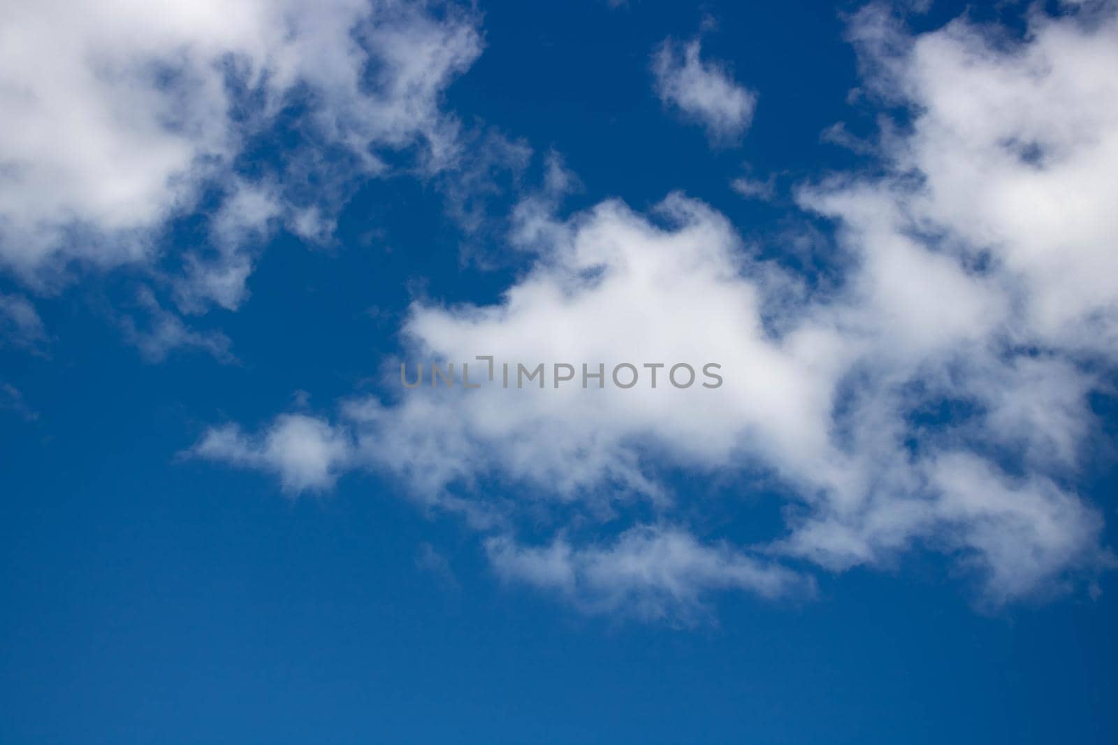 Beautiful sky background. Oddly shaped clouds in a blue sky.