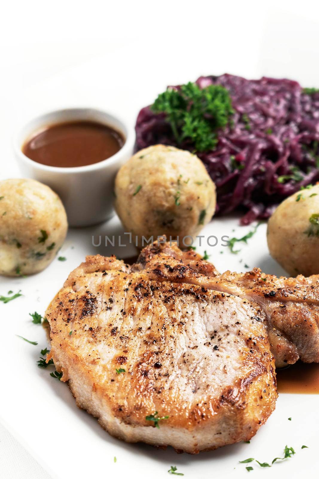 german style grilled pork chop with bread dumplings traditional meal by jackmalipan