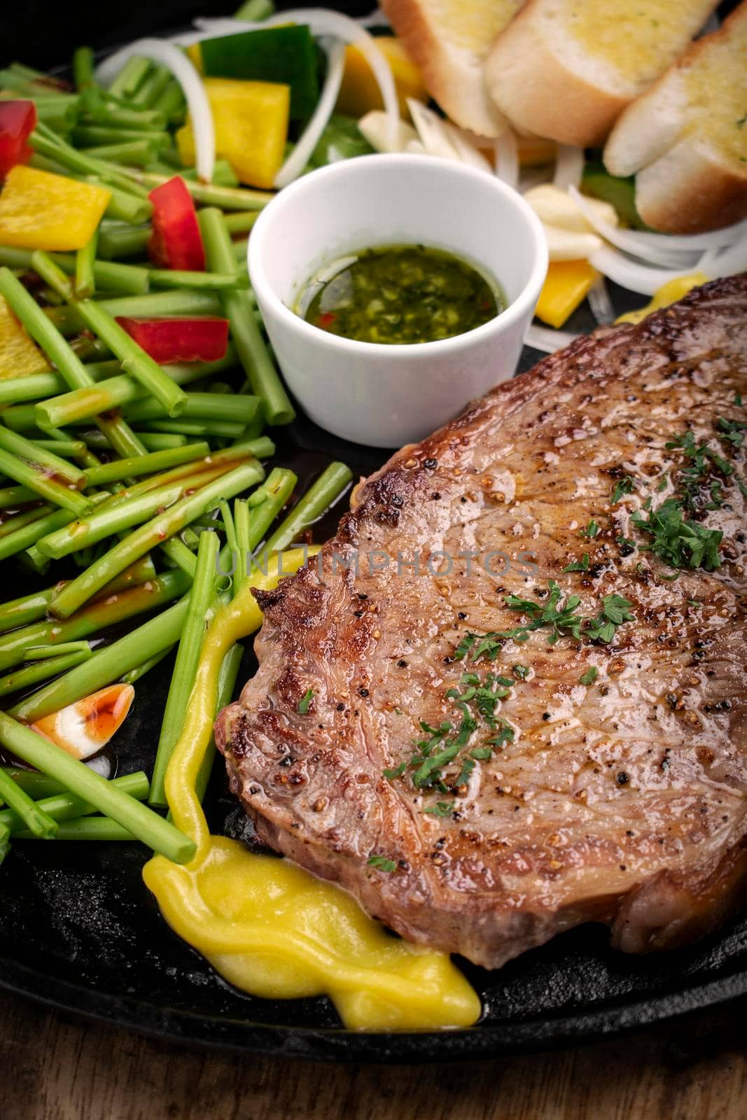 organic tenderloin beef steak sizzler on hot plate meal platter by jackmalipan