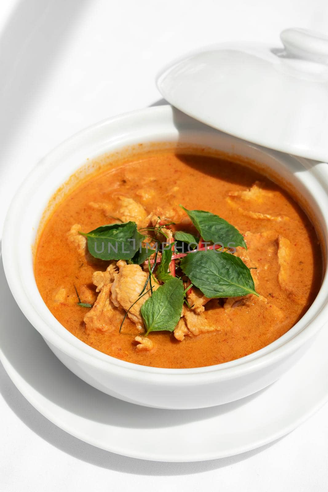 thai spicy panang pork curry with coconut milk on restaurant table in Phuket Thailand