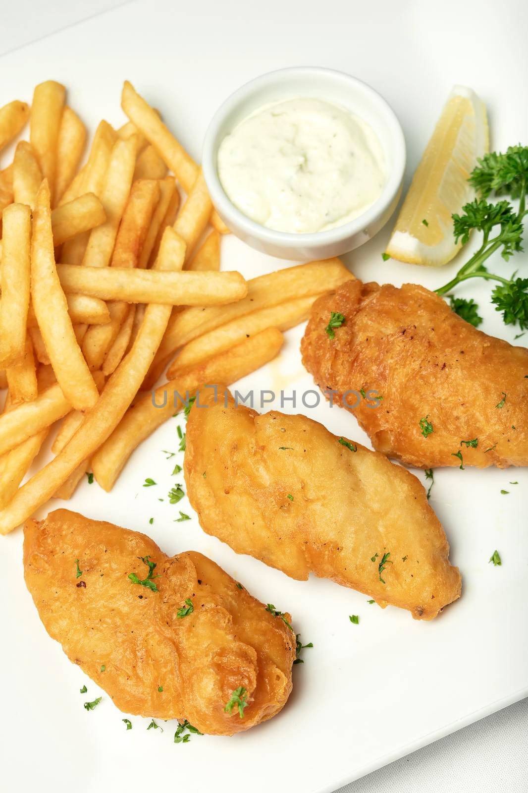 british traditional fish and chips meal on white plate