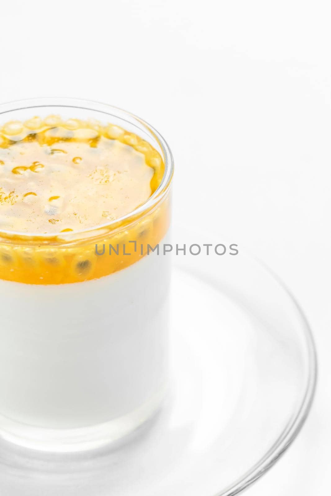 vegan dairy free organic coconut cream panna cotta with passion fruit dessert on white background