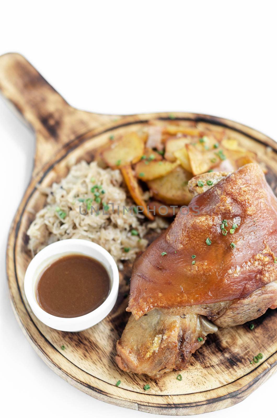 SCHWEINSHAXE traditional german pork knuckle with sauerkraut and potatoes meal on white background