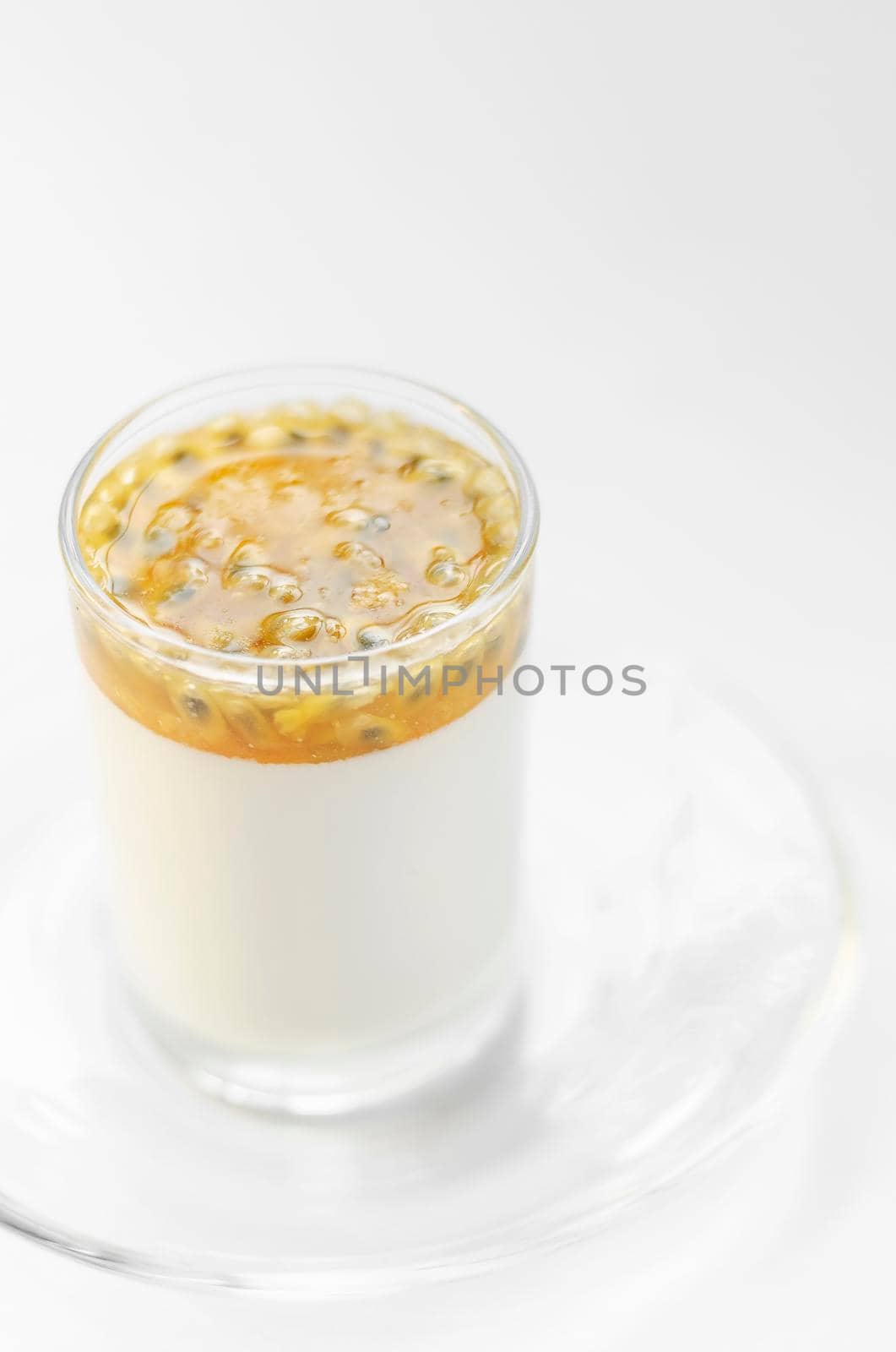 vegan dairy free organic coconut cream panna cotta with passion fruit dessert on white background