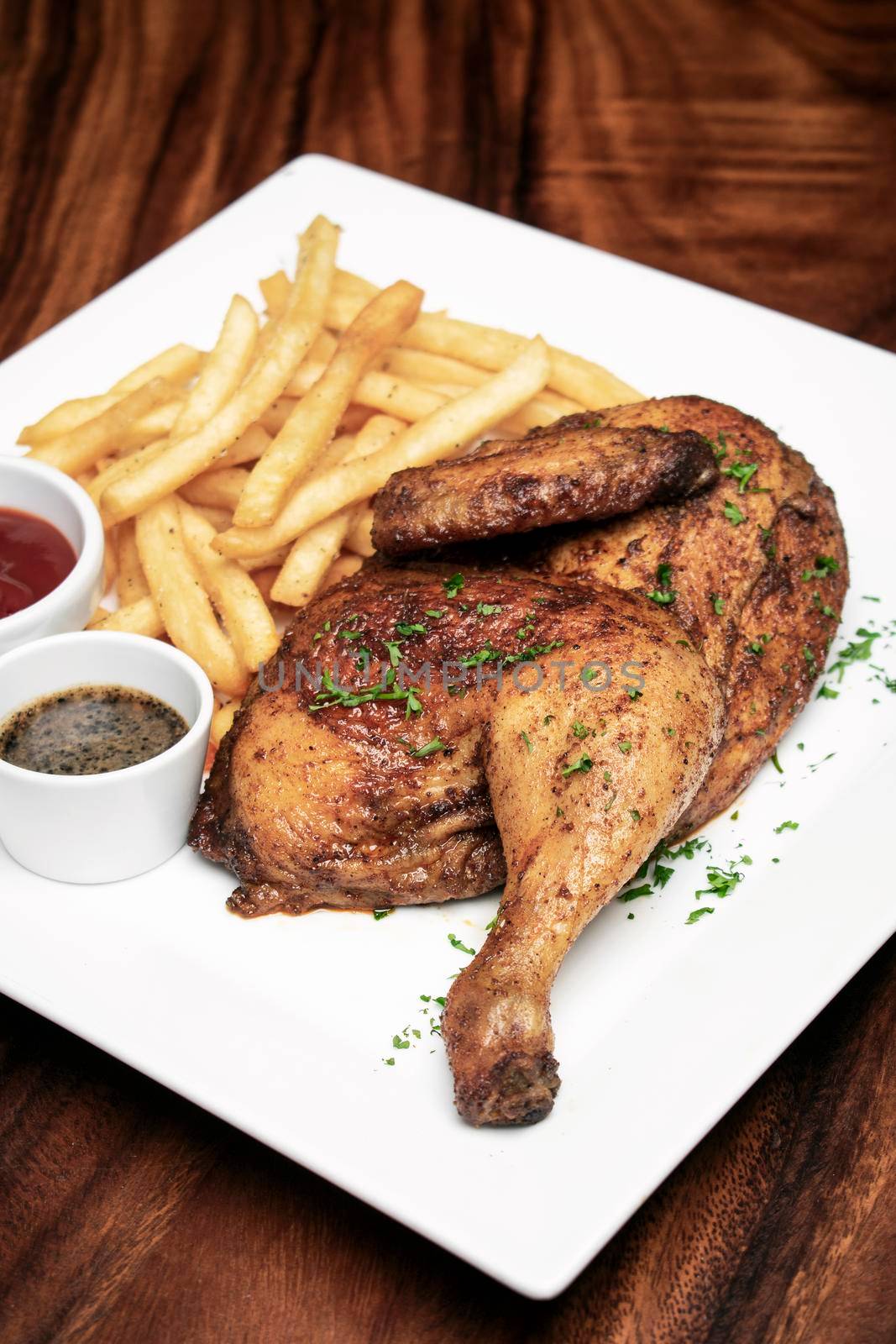 roast rotisserie half chicken with french fries simple meal on wood table
