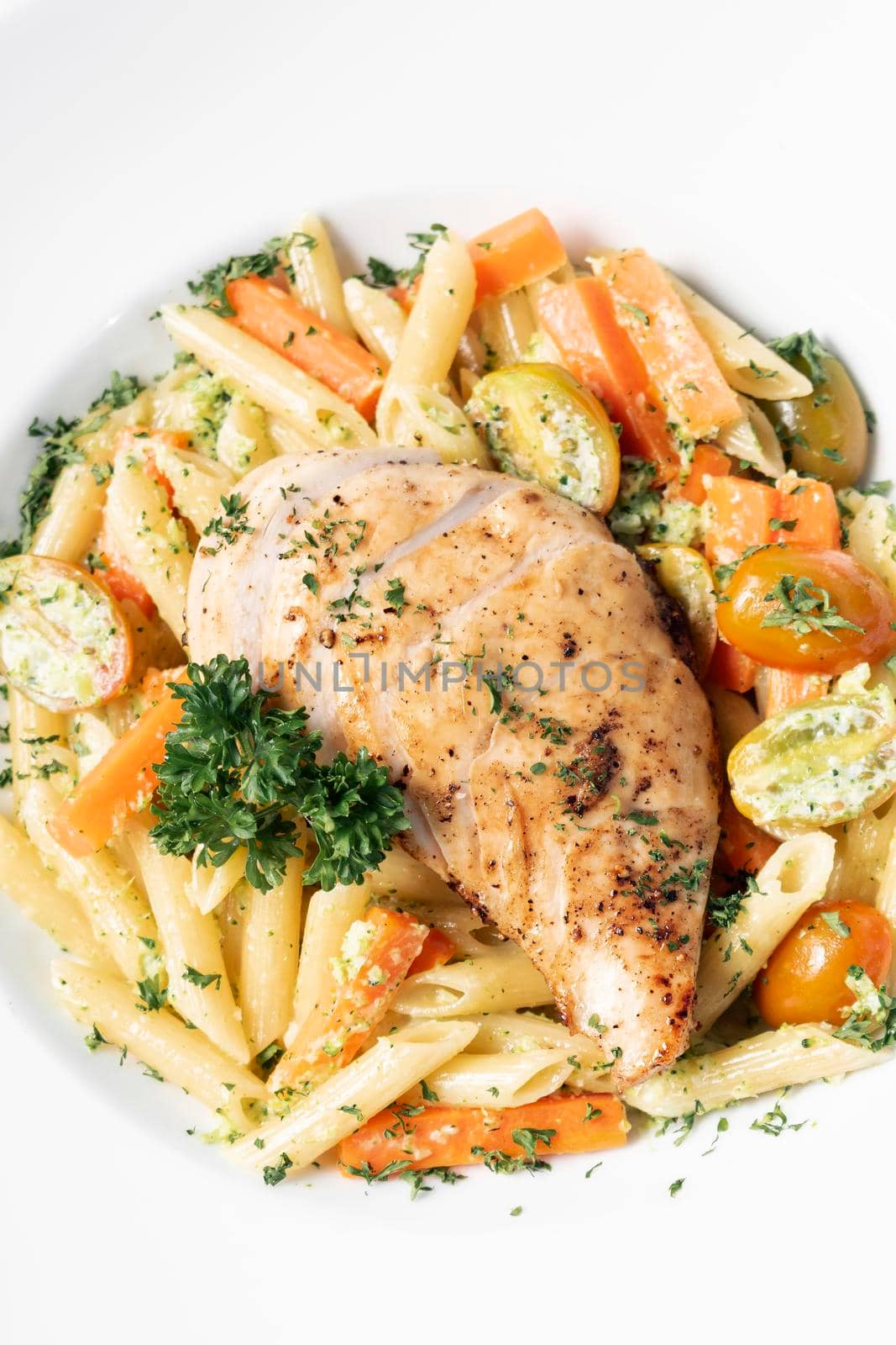 fried chicken breast with penne and saute vegetables pasta dish by jackmalipan