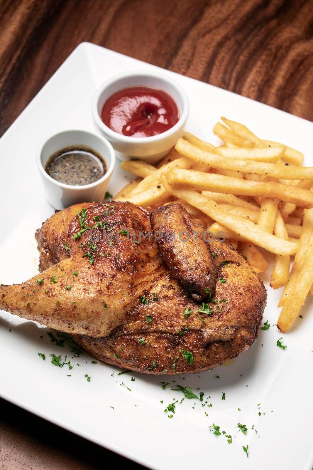 roast rotisserie half chicken with french fries simple meal on wood table