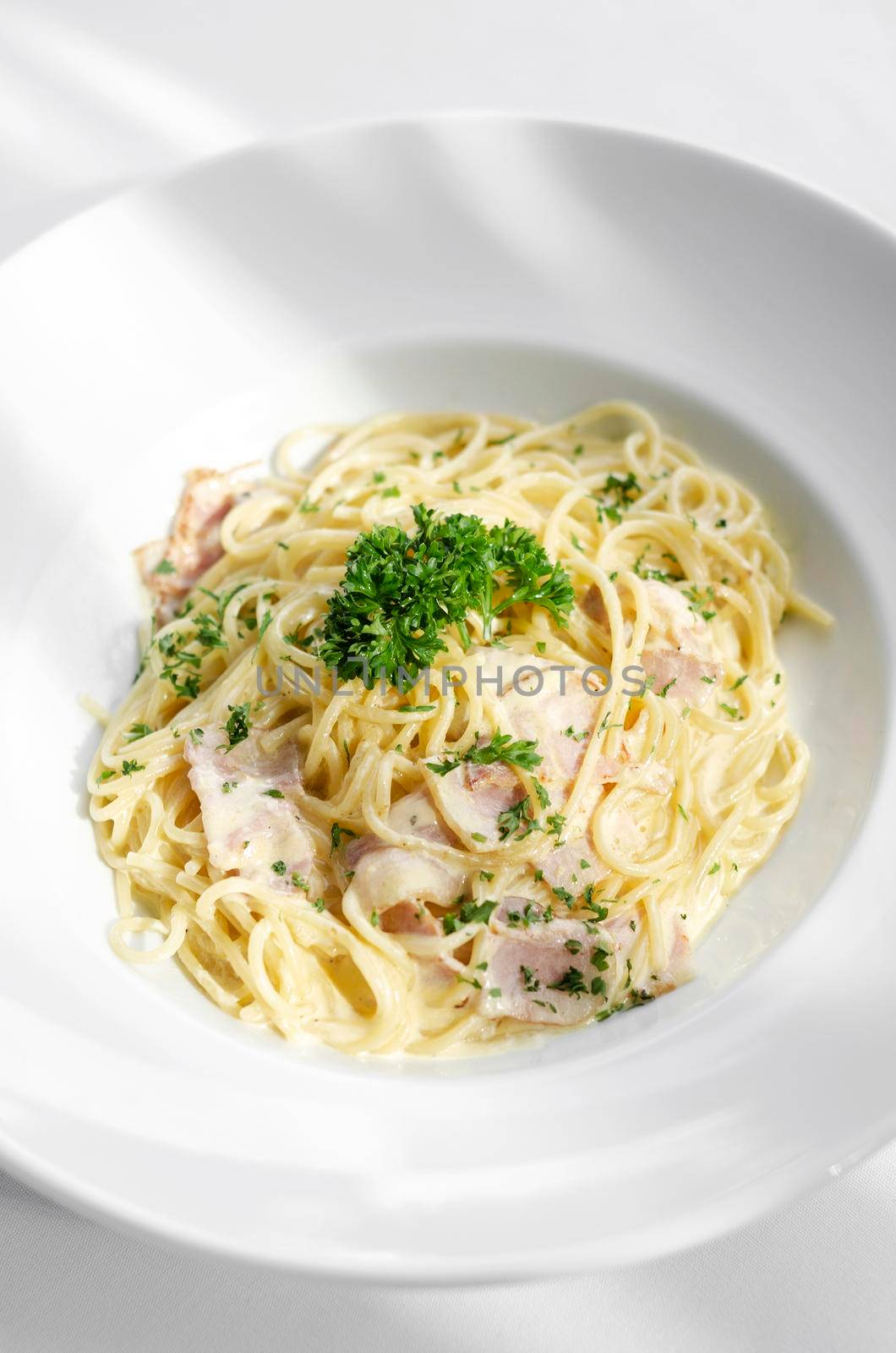 spaghetti carbonara pasta dish on white table background by jackmalipan