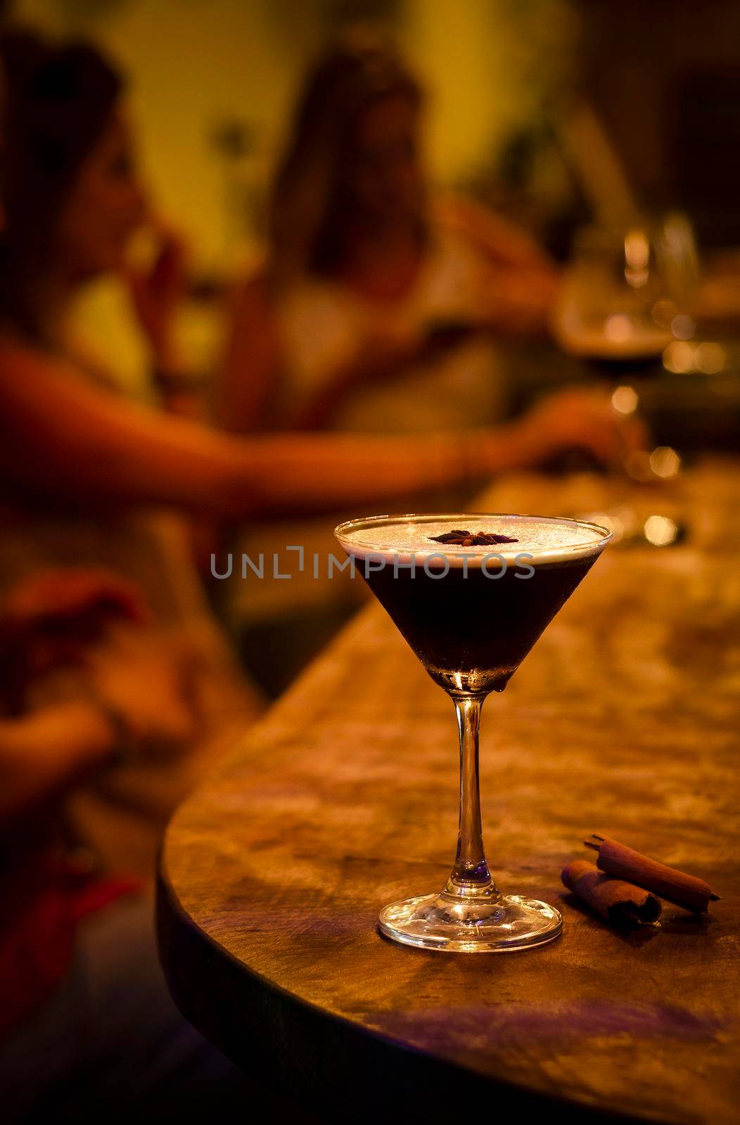 espresso martini cocktail drink in cozy dark bar interior at night