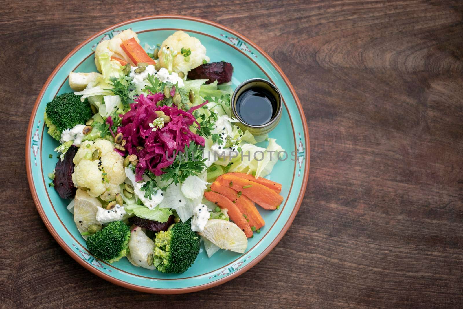 rustic cottage salad with healthy mixed steamed and fresh vegetables on colorful plate
