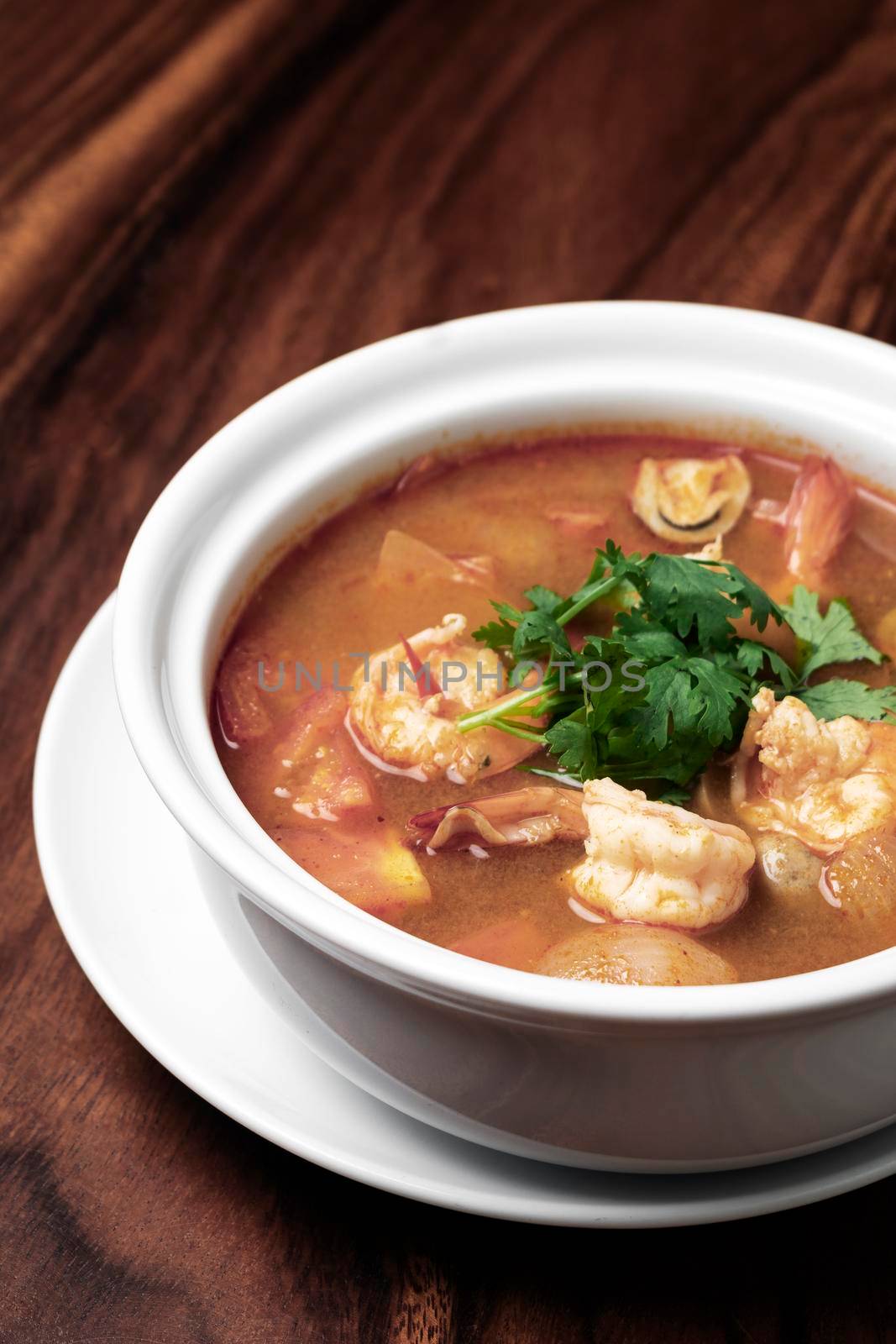 thai tom yum kung spicy and sour shrimp soup on wood table background in phuket thailand