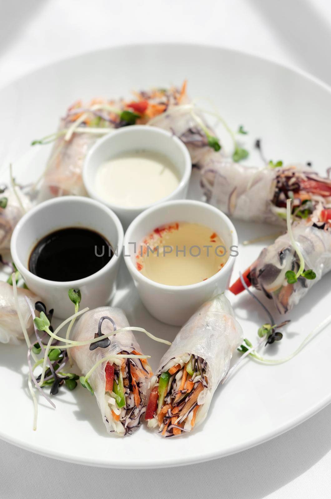 asian fresh vegetable vegan spring rolls with sauces in vietnam by jackmalipan
