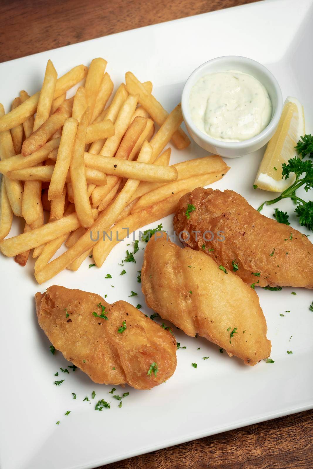 british traditional fish and chips meal on wood table