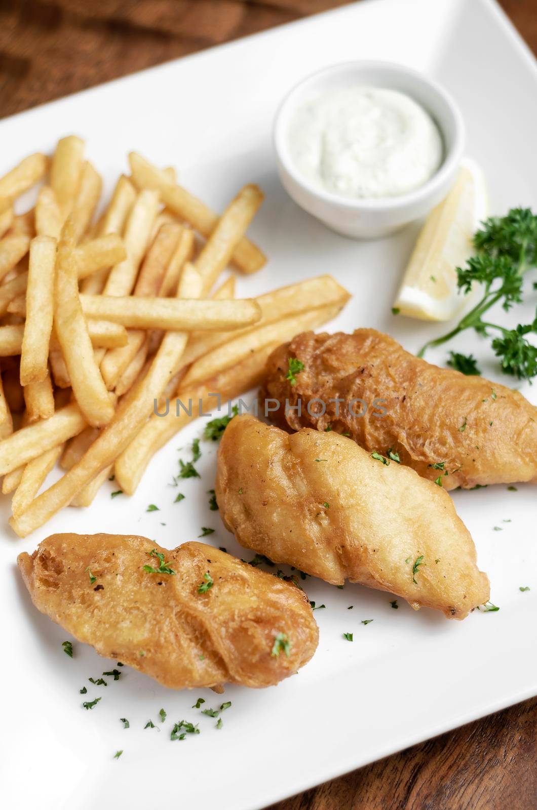 british traditional fish and chips meal on wood table