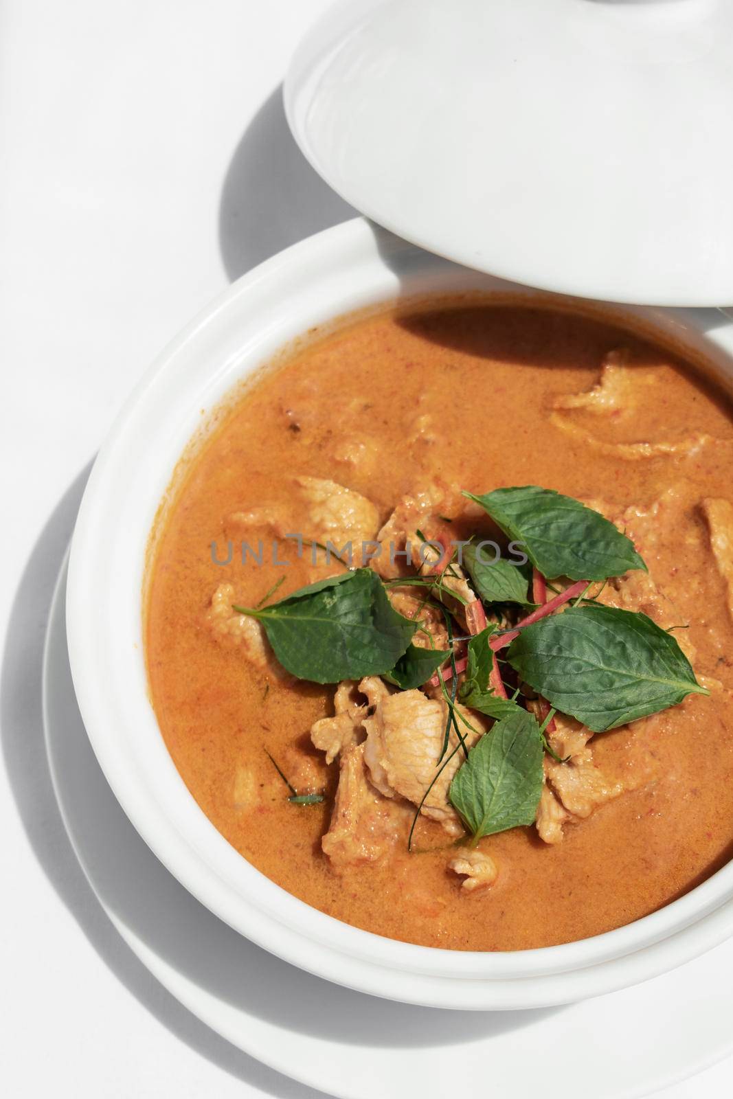 thai spicy panang pork curry with coconut milk on restaurant table in Phuket Thailand