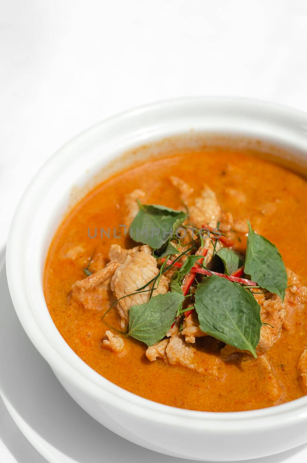 thai spicy panang pork curry with coconut milk on restaurant table in Phuket Thailand