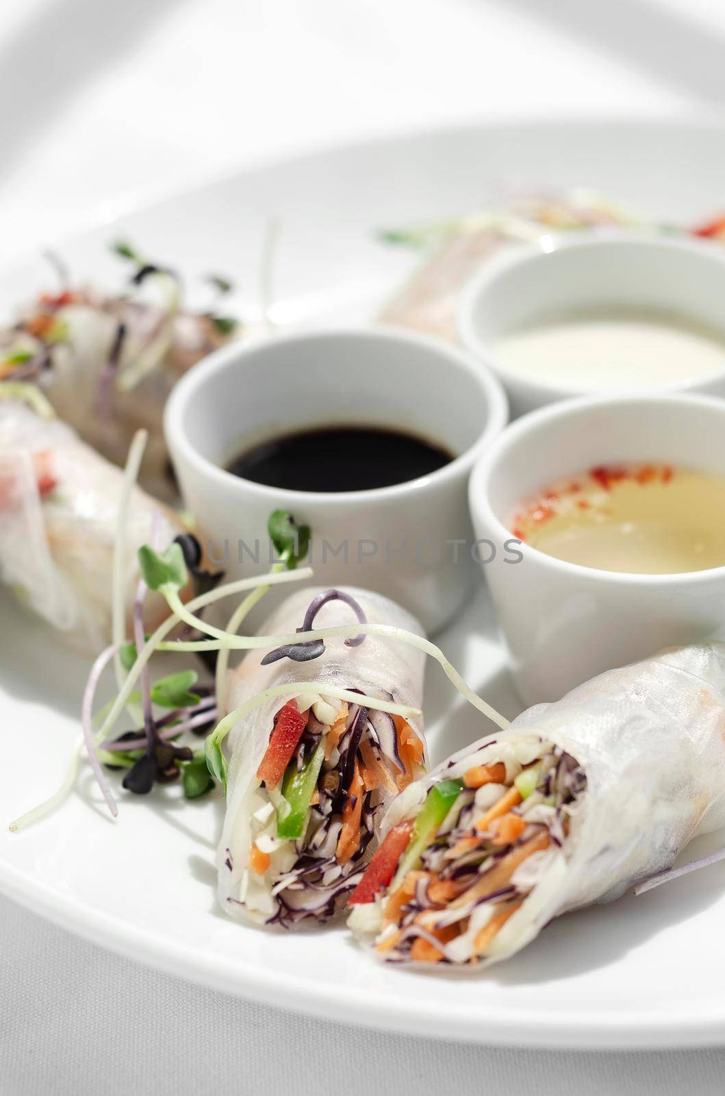asian fresh vegetable vegan spring rolls with sauces in vietnam