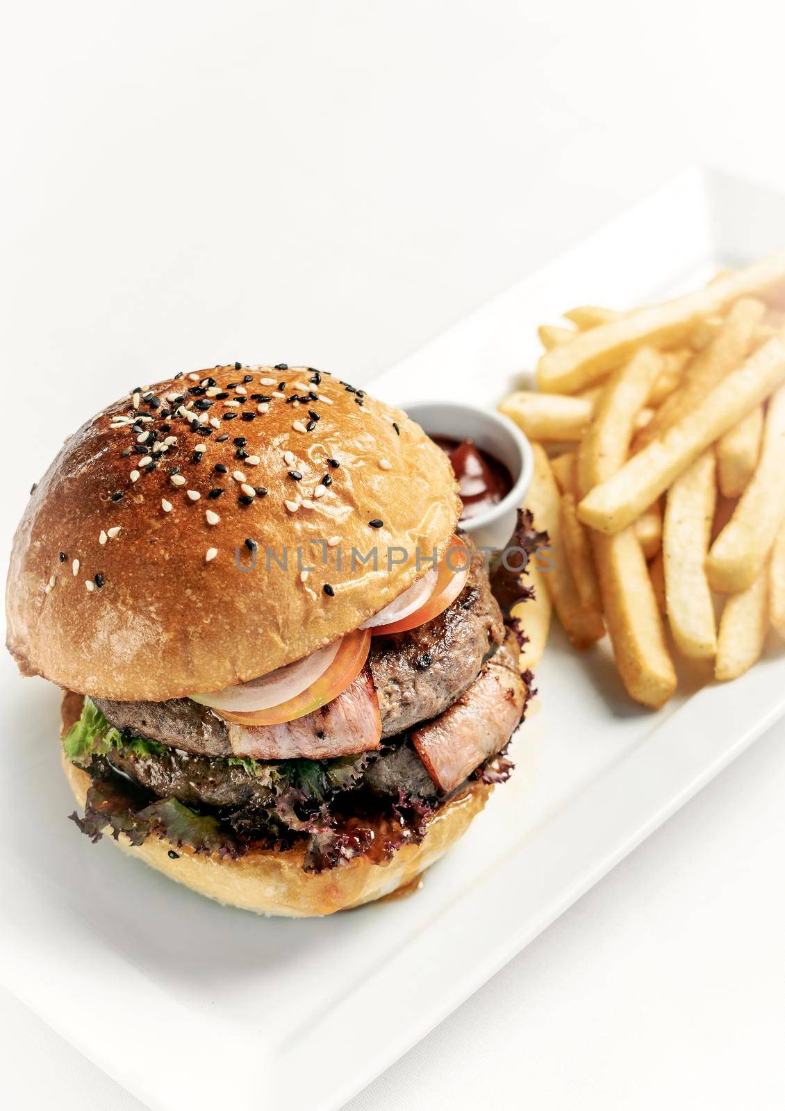 australian organic beef burger with french fries platter on white studio background