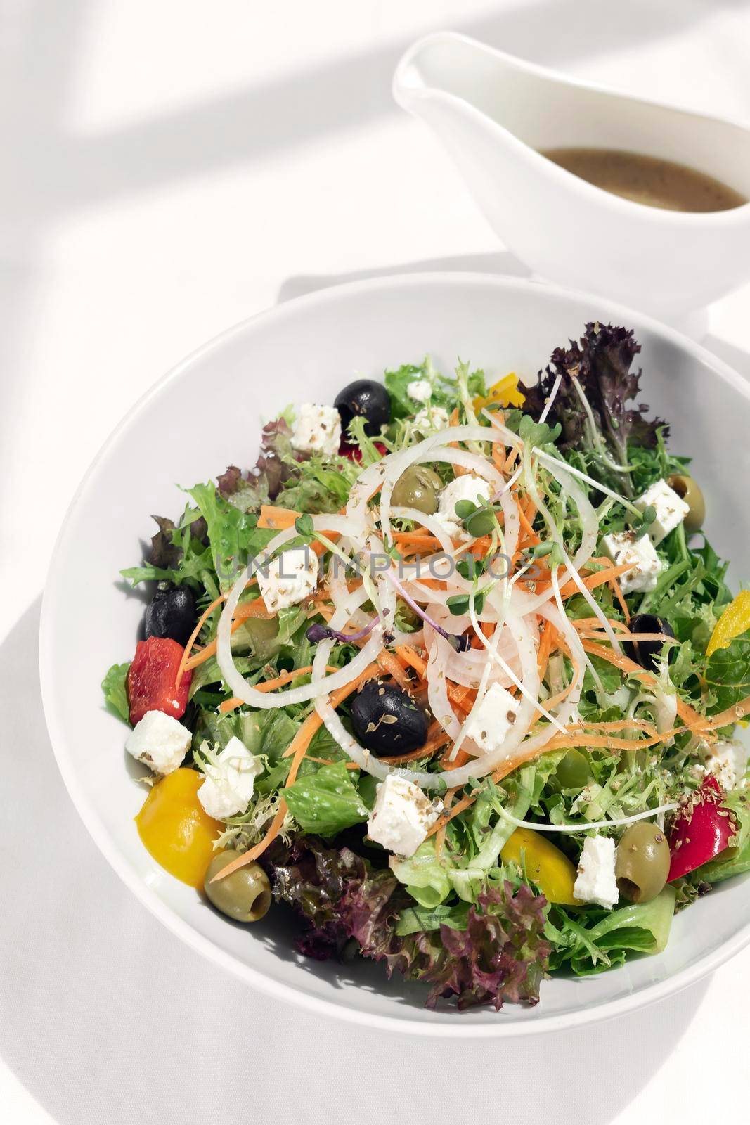 greek salad with feta cheese and olives with citrus vinaigrette by jackmalipan