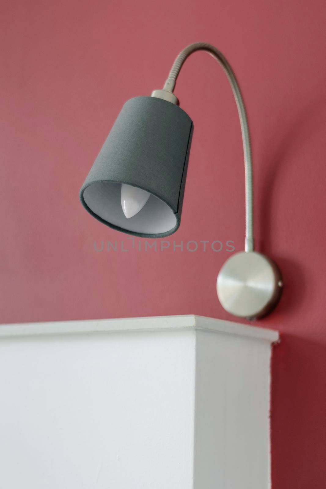 modern design bed lamps detail in contemporary bedroom interior at daytime
