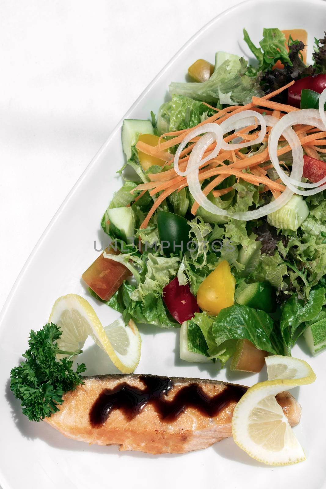 organic mixed vegetable salad with salmon fillet and balsamic vinaigrette by jackmalipan
