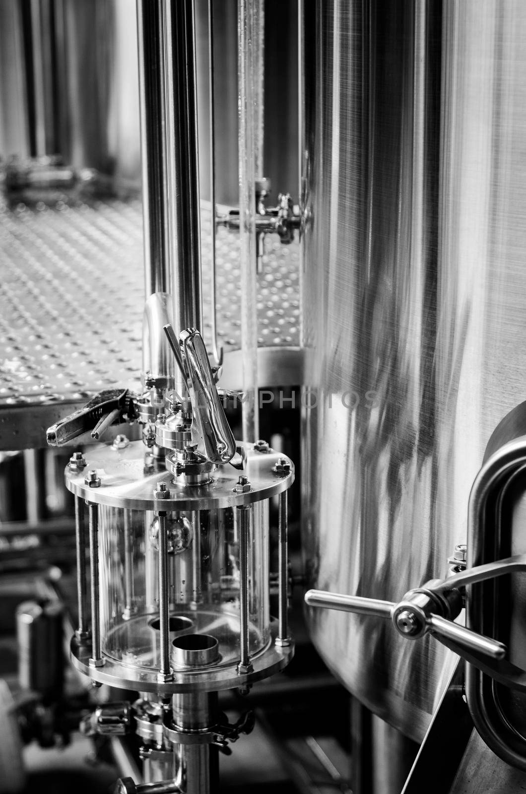 industrial beer brewing equipment detail in brewery interior by jackmalipan