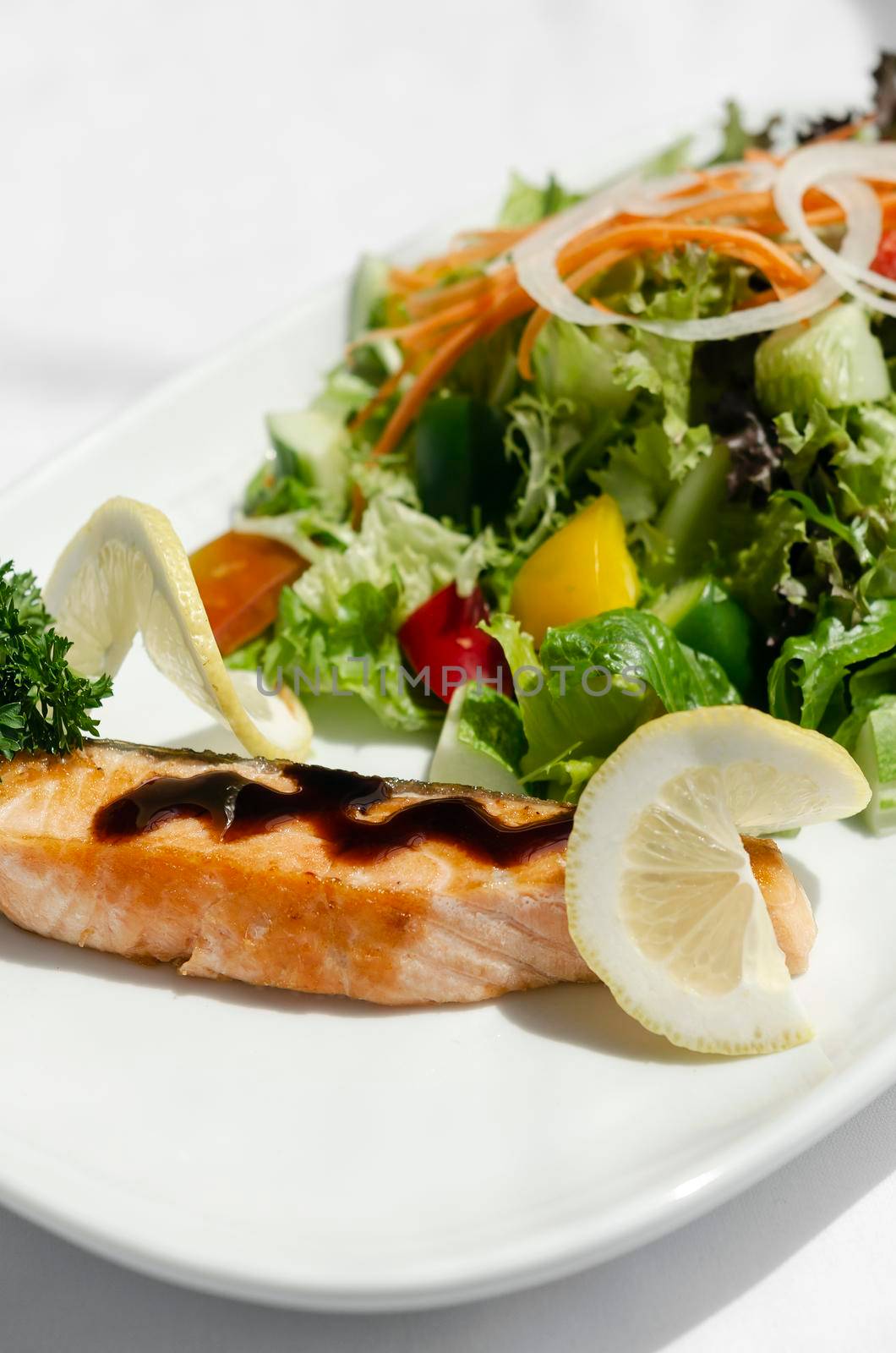 organic mixed vegetable salad with salmon fillet and balsamic vinaigrette by jackmalipan