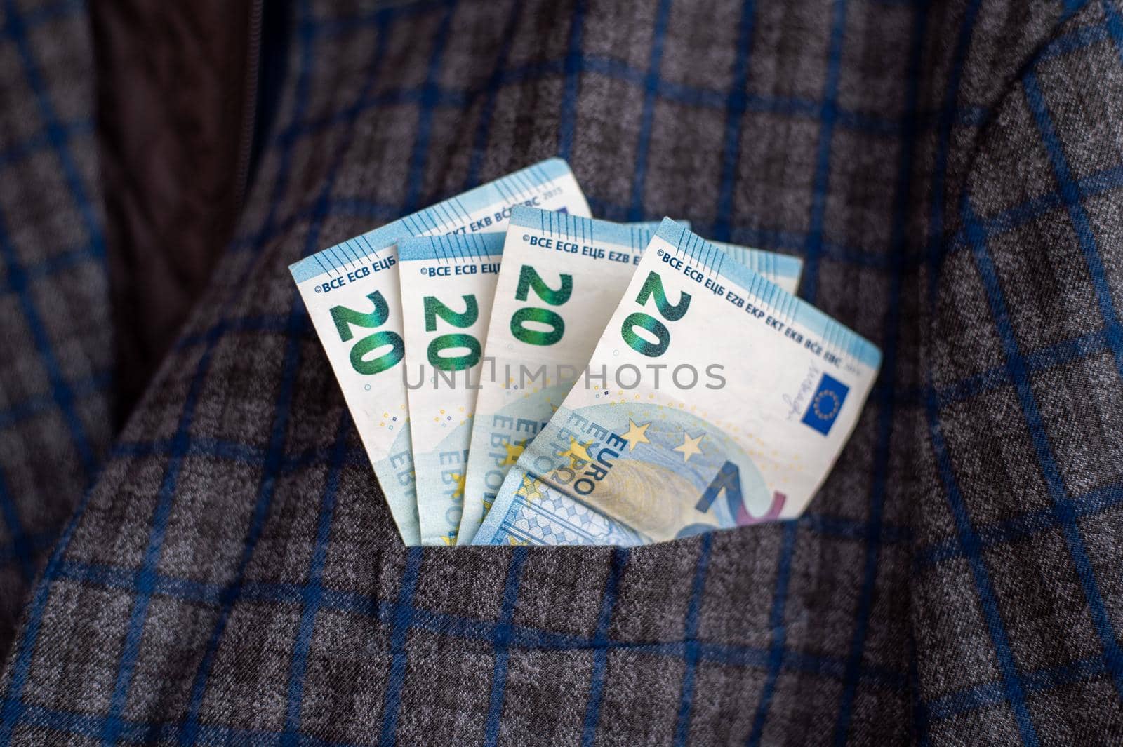 pocket of the plaid jacket coming out of 20 euro bills