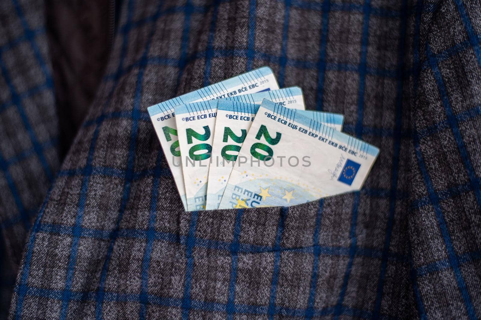 pocket of the plaid jacket coming out of 20 euro bills