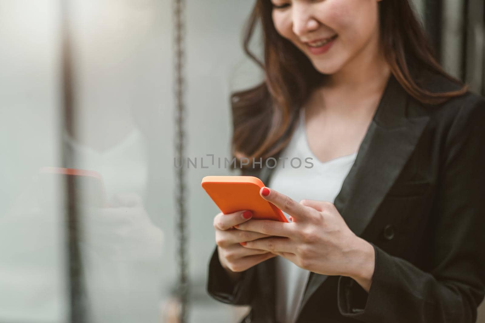 Business woman using smartphone shopping online, call, texting message internet technology lifestyle. Asian woman using cellphone at modern office.