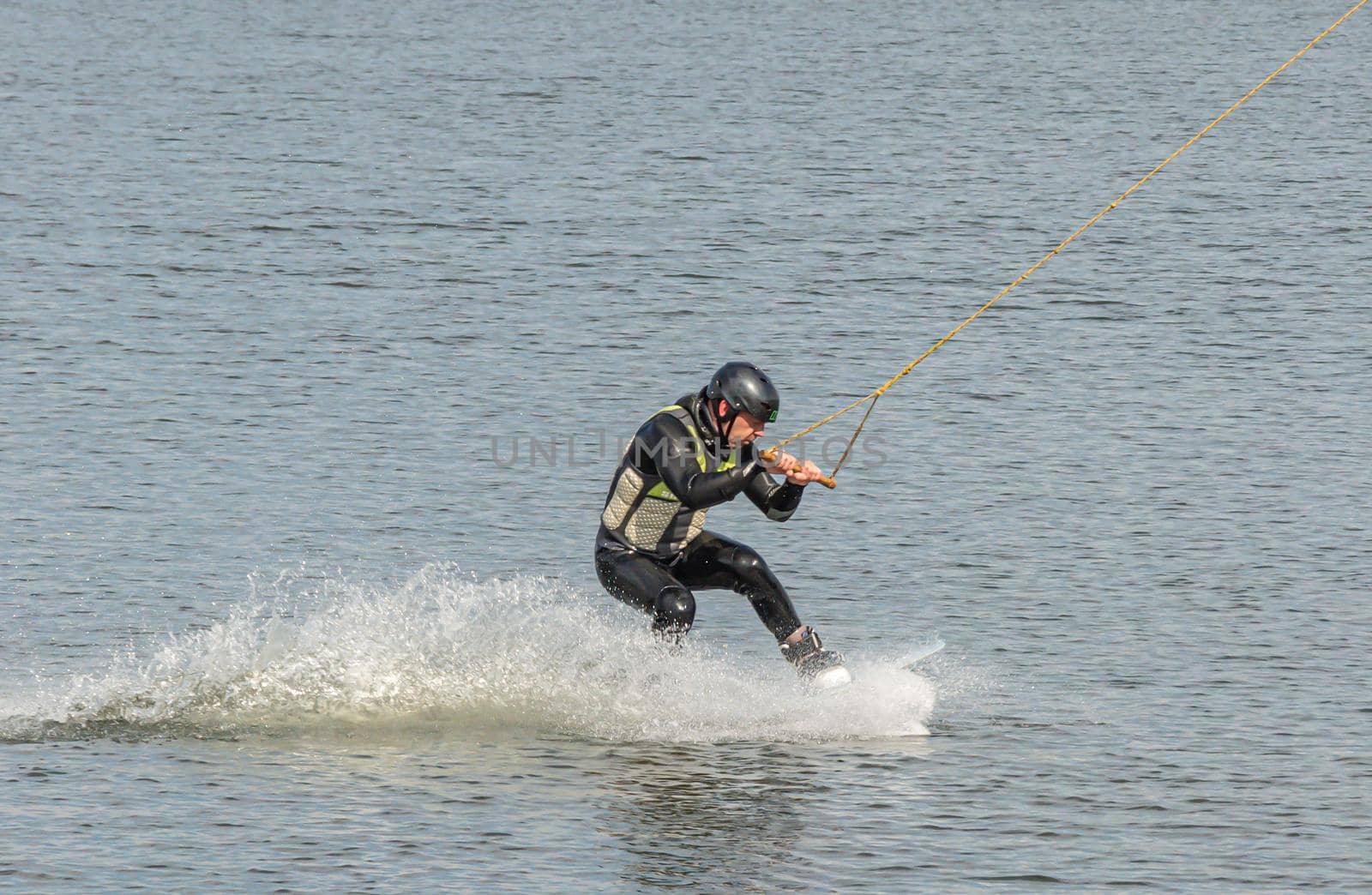 Spain, Tenerife Island - May 28, 2021: Sports. The kitesurfer sat down on the board. Stock photography.