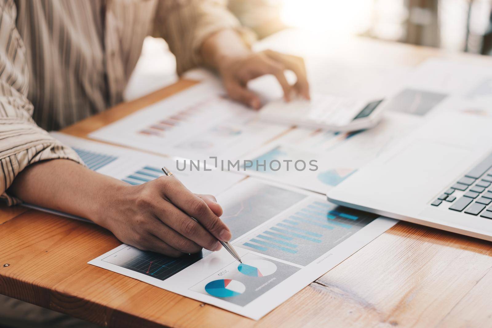 Financial Business man analyze the graph of the company's performance to create profits and growth, Market research reports and income statistics, Financial Accounting concept.