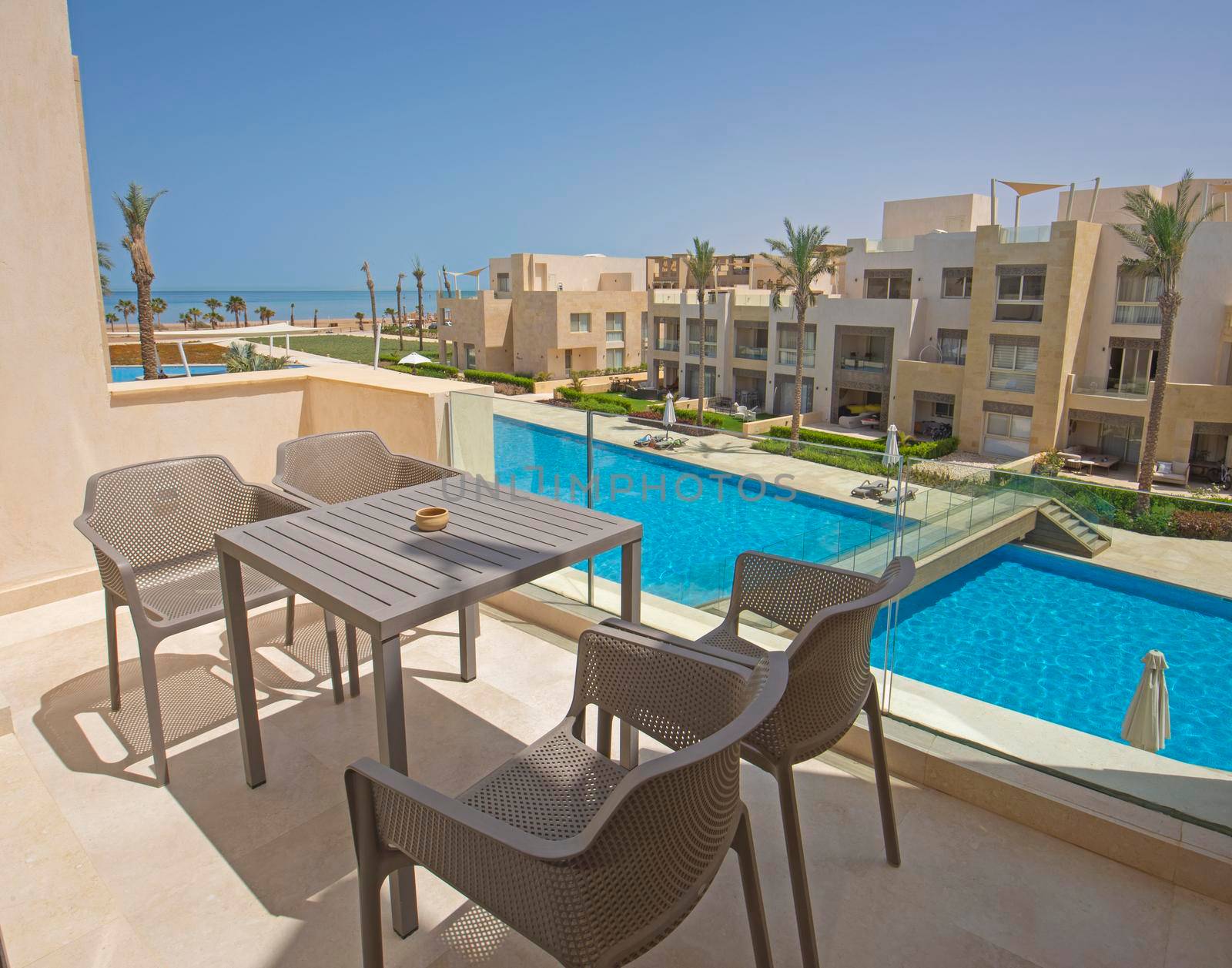 Terrace furniture of a luxury apartment in tropical resort with furniture and sea view from balcony