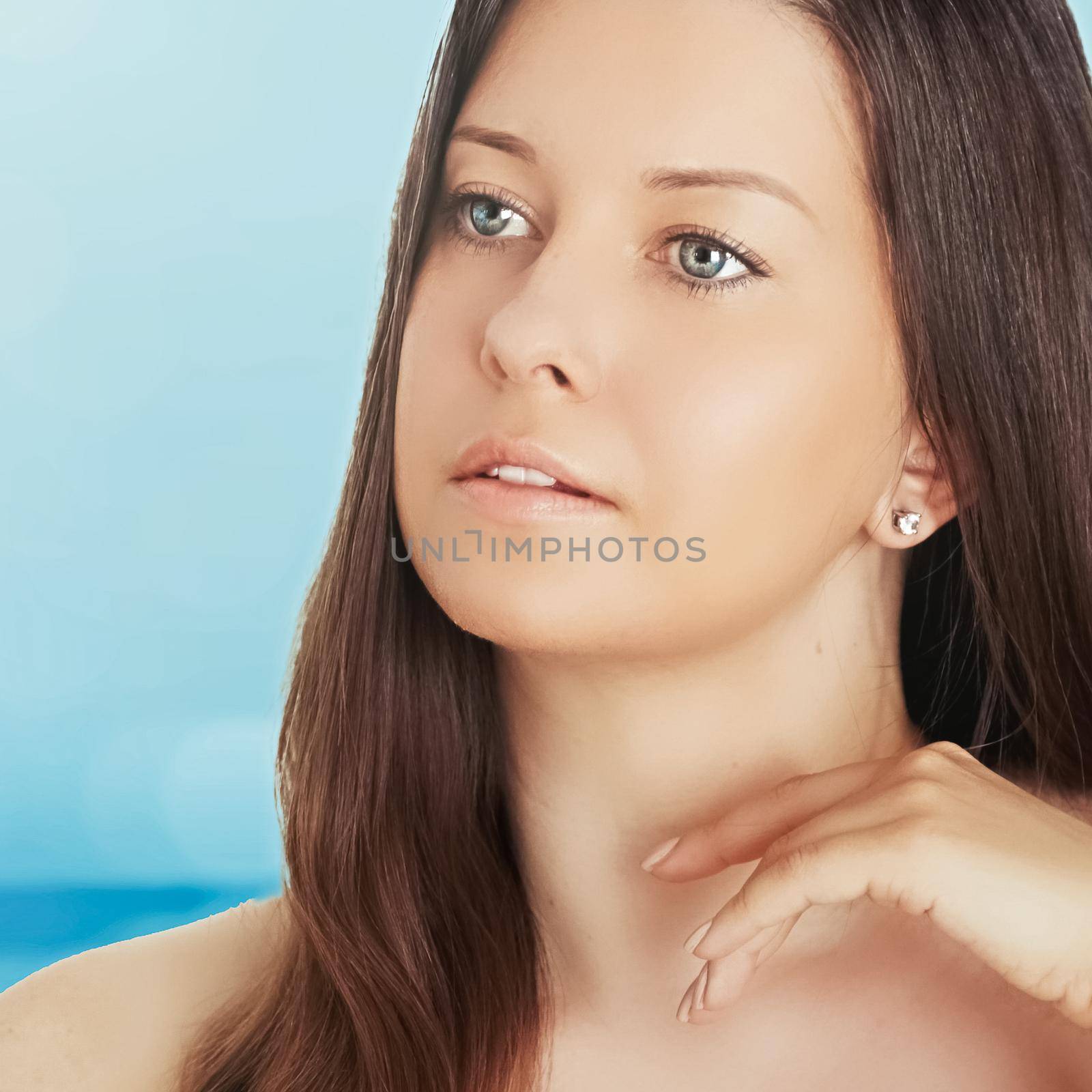 Skincare and sun protection in summer. Portrait of a beautiful young suntanned woman, blue sea and sky on background, beauty, wellness and travel concept by Anneleven