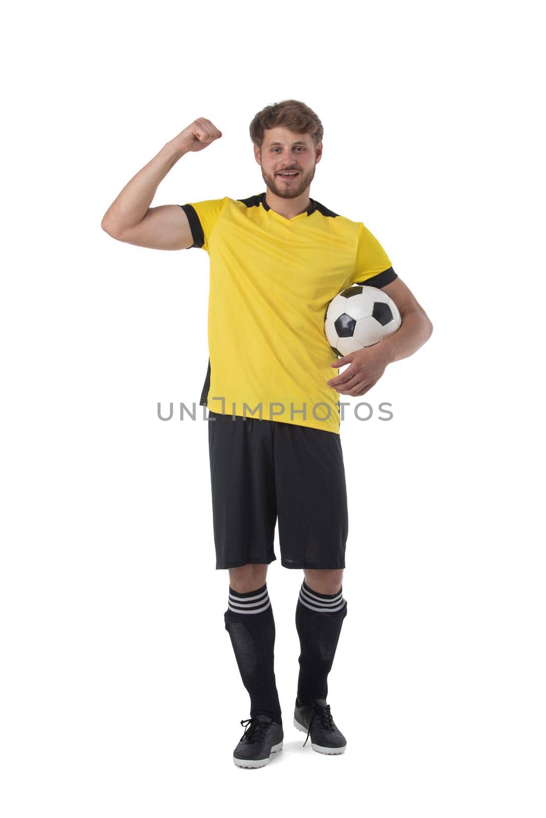 Soccer player is holding ball showing muscle holding fist celebrating victory isolated on white background