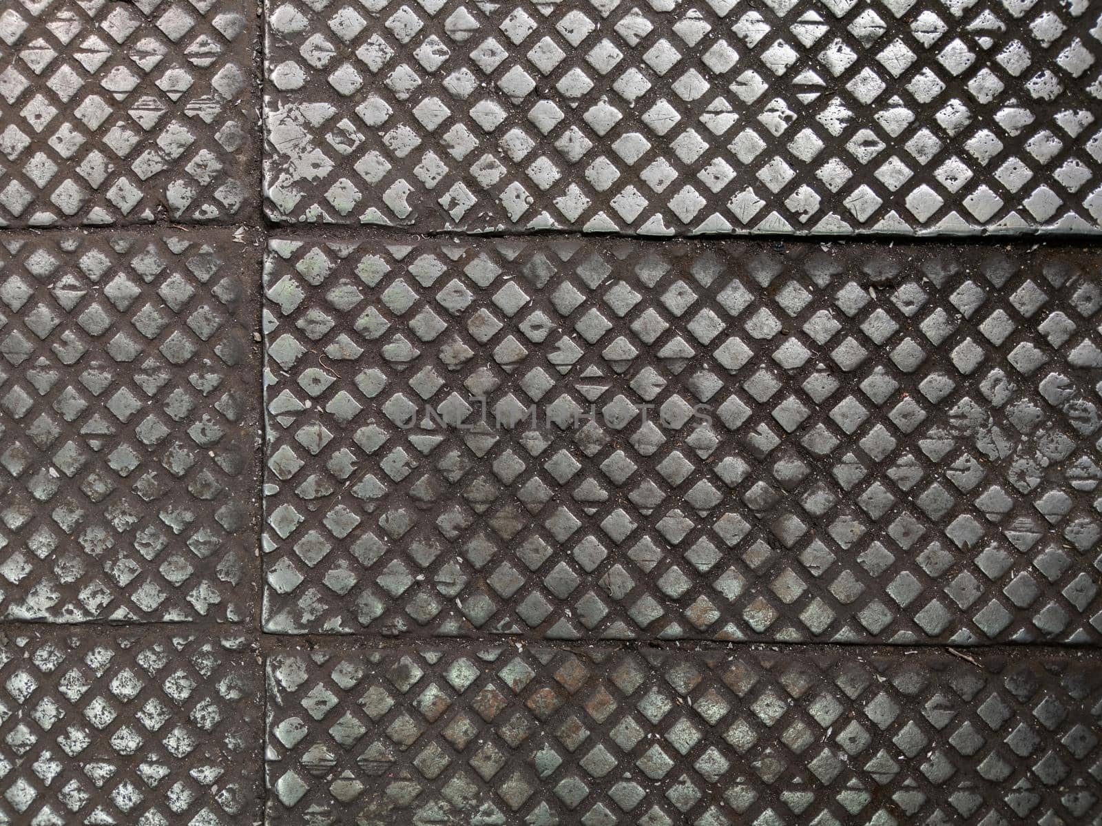 old cast iron factory floor tiles with checkered skid-proof pattern by z1b