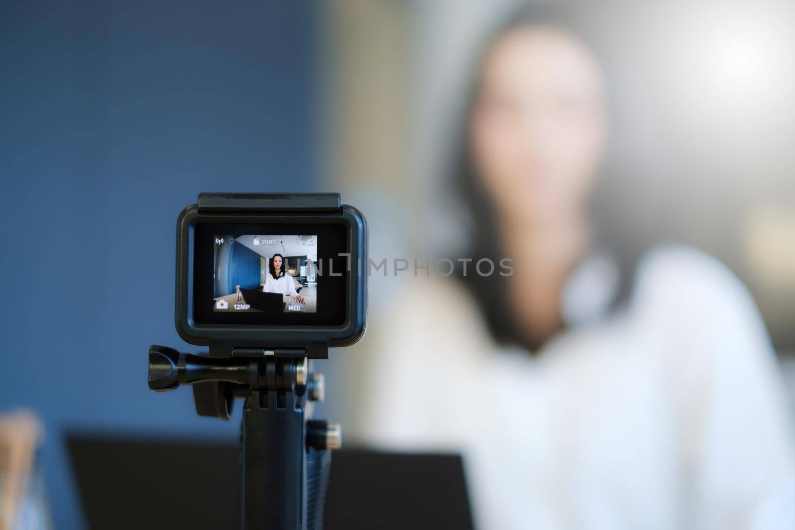 Business woman or blogger recording vlog on digital camera and live stream