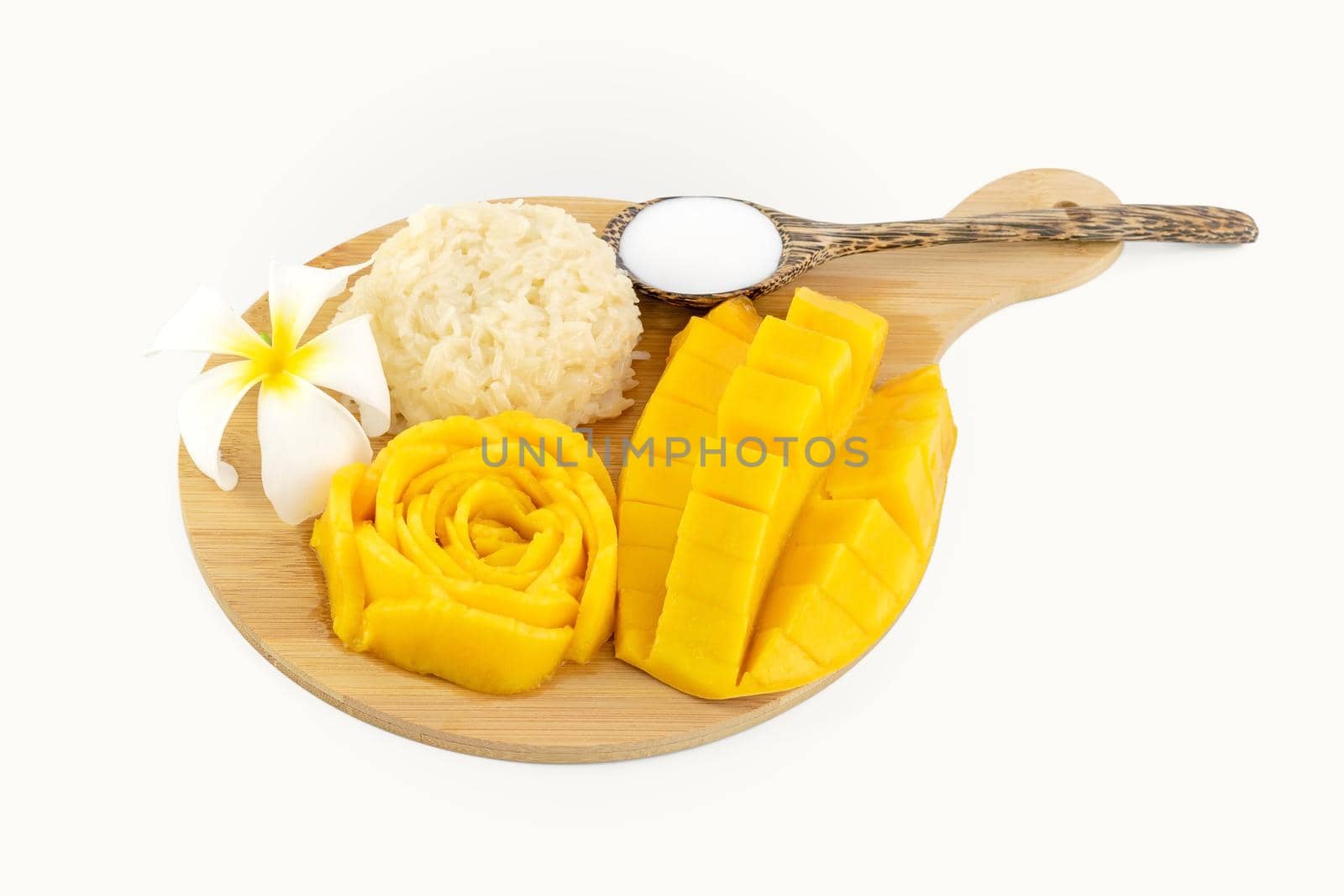 Mango Sticky Rice with flower on a wooden plate over white background by wattanaphob