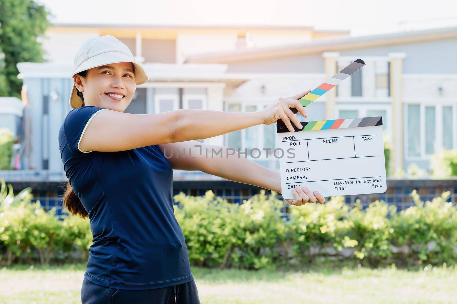 Asian woman holding film slate colors board for movie cinema and television industry by wattanaphob