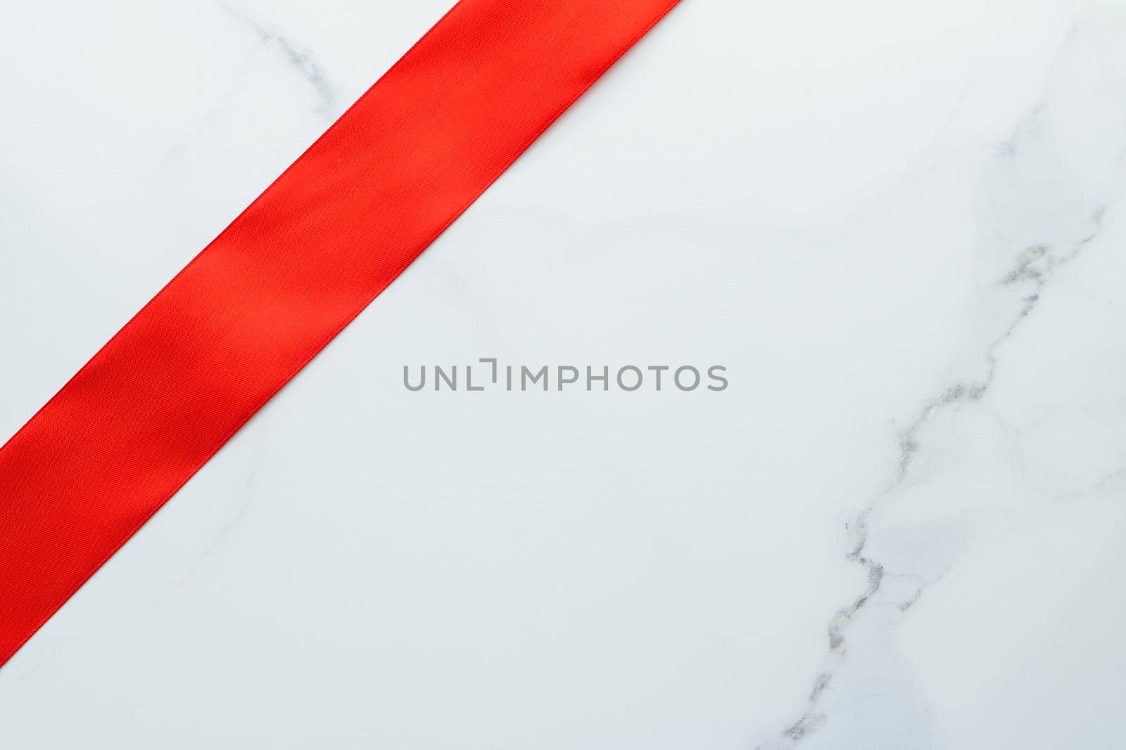 Holiday decor, feminine design and flatlay concept - Red silk ribbon on marble, top view