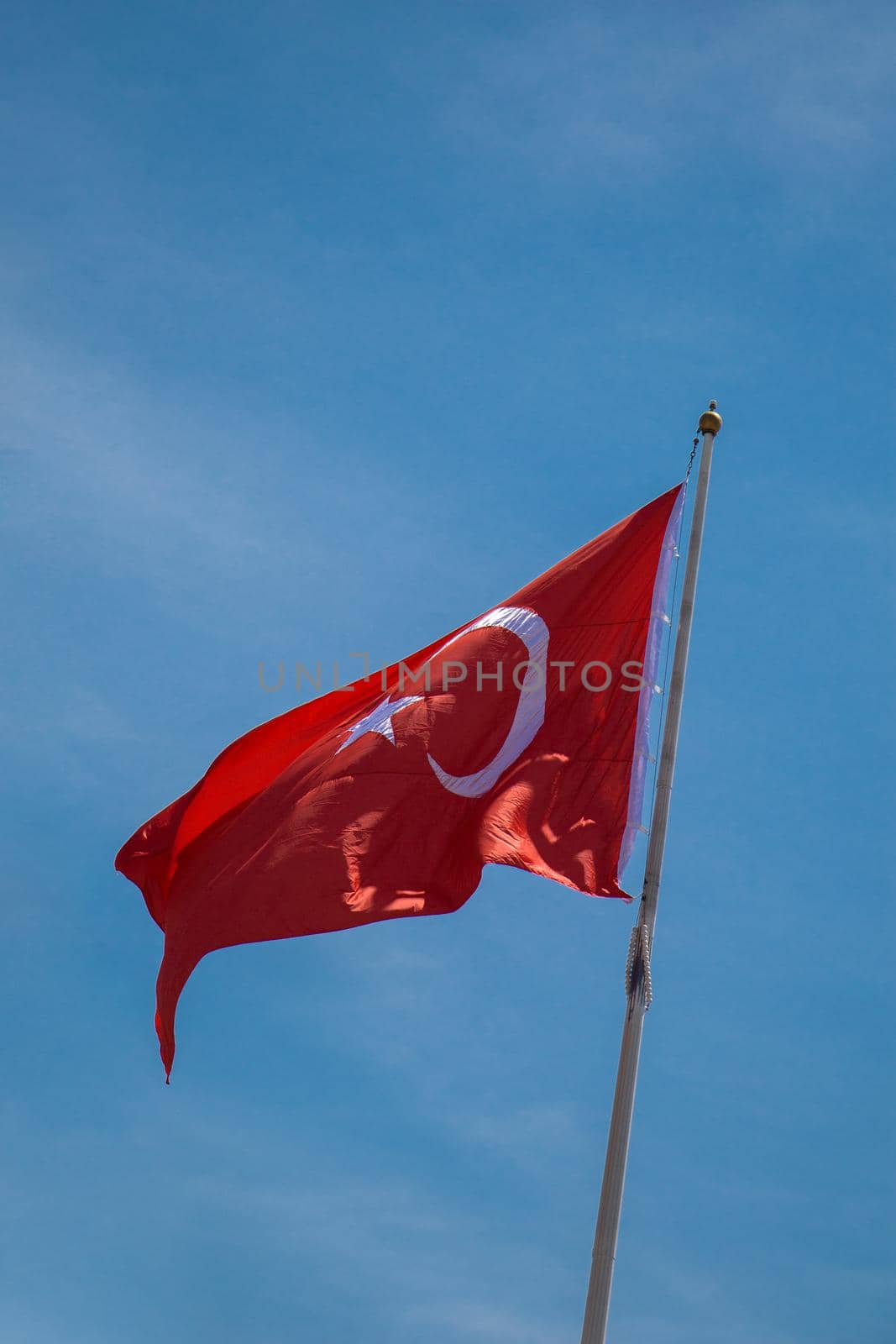 Turkish national flag with white star and moon in sky by berkay