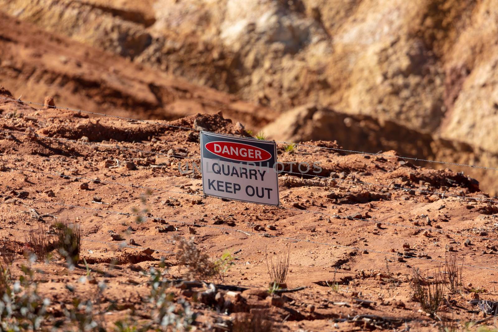 Photograph of a keep out danger sign in a large quarry by WittkePhotos