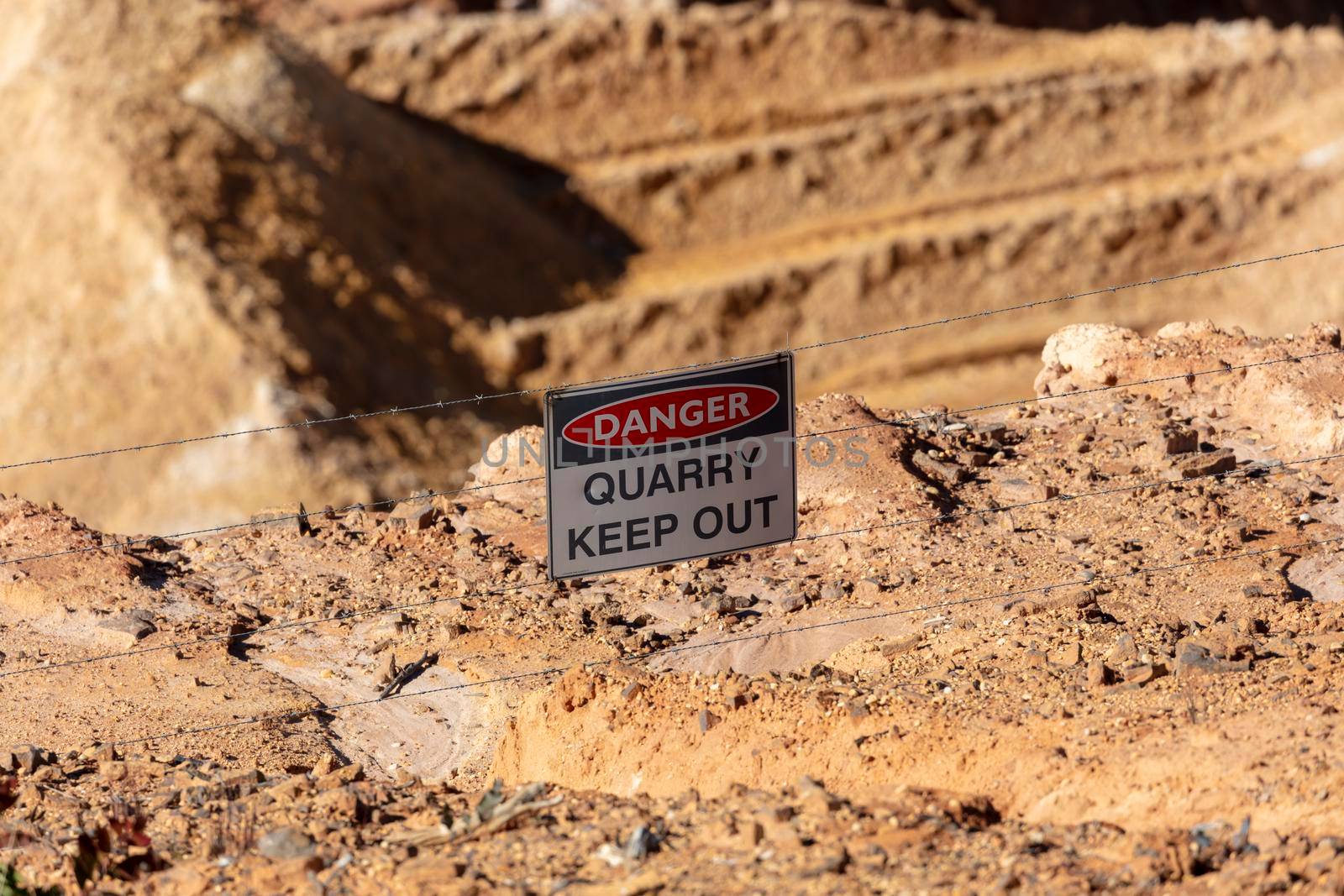 Photograph of a keep out danger sign in a large quarry by WittkePhotos