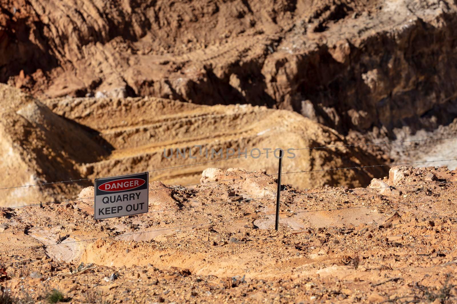 Photograph of a keep out danger sign in a large quarry by WittkePhotos