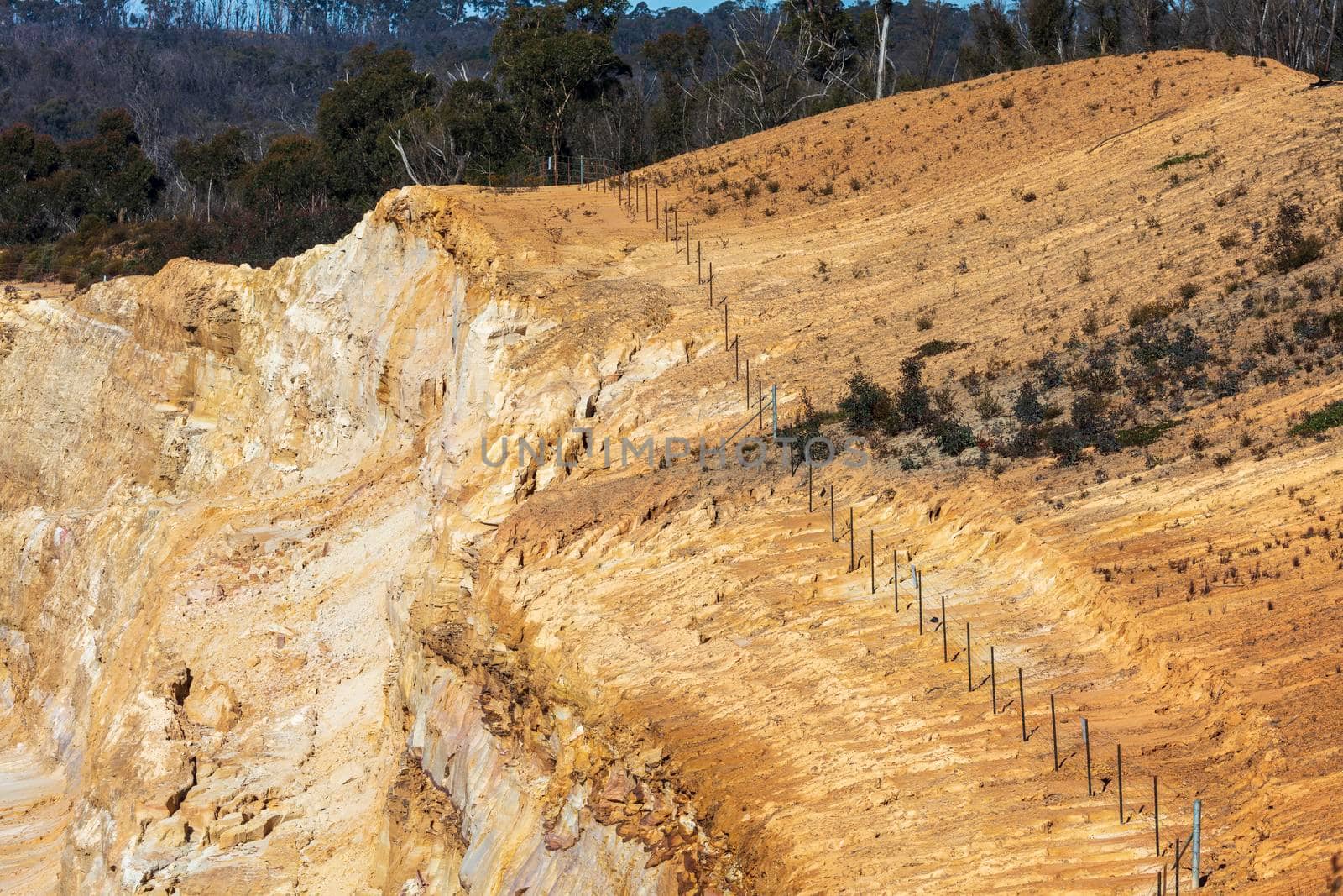 Photograph of crushed sand and stone laying on the ground in a large quarry