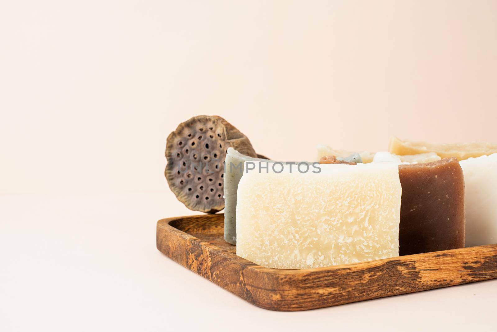 Natural cosmetics. Stack of hand made soap with lotus on beige background with copy space