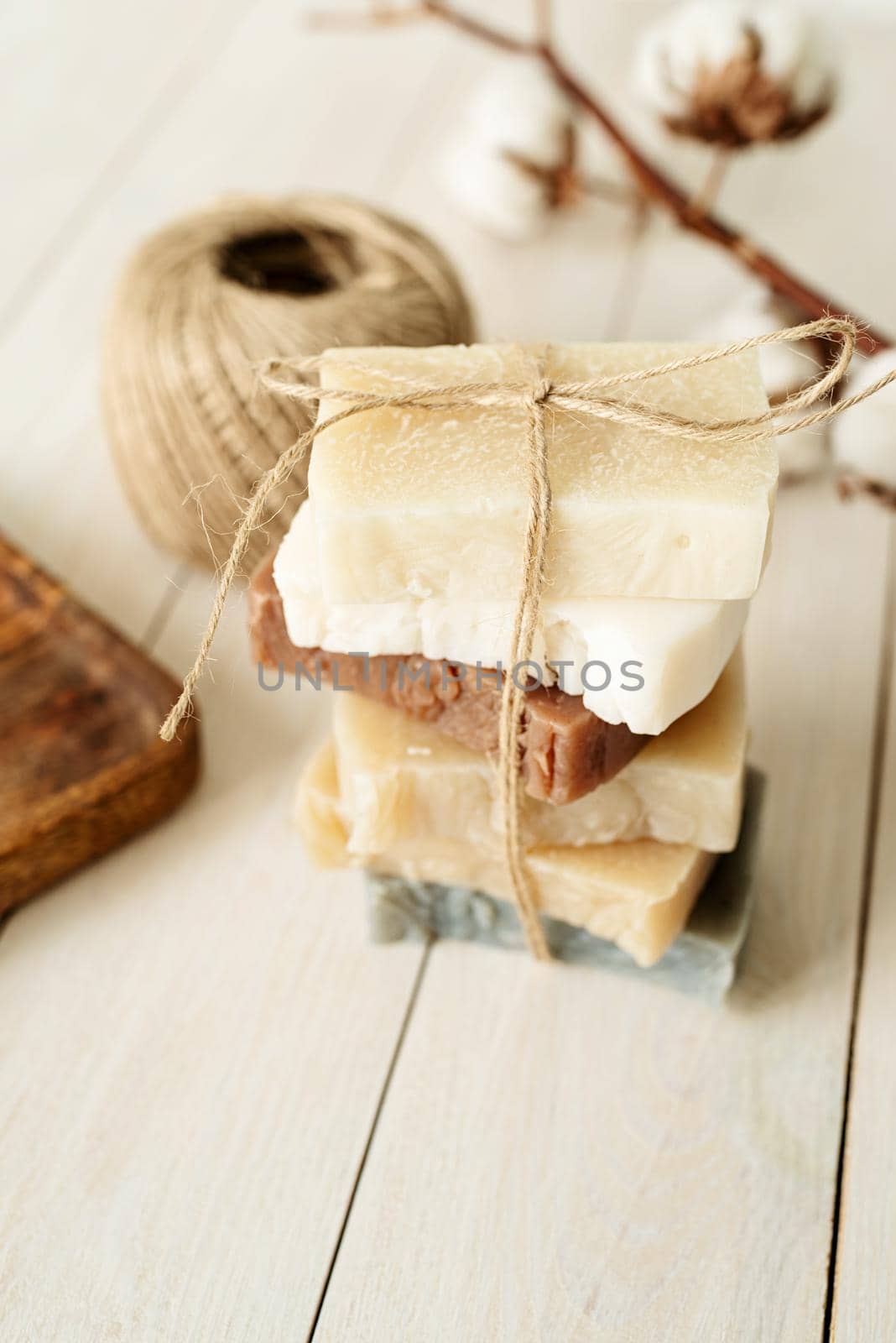 Natural organic cosmetics. Stack of hand made soap on white wooden background