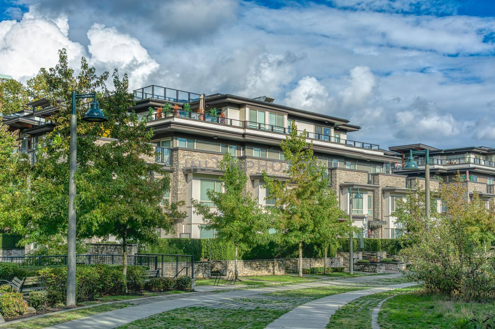 Residential apartment building on cloudy sky background.