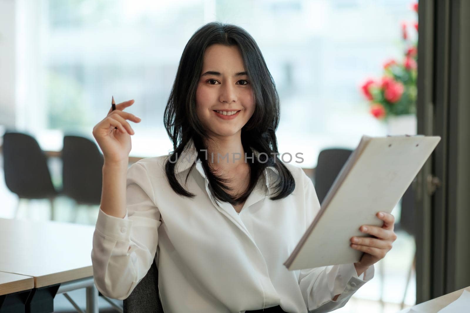 Portrait of smiling beautiful business asian woman with suit working in office desk using computer with copy space. Business people employee freelance online marketing e-commerce telemarketing concept